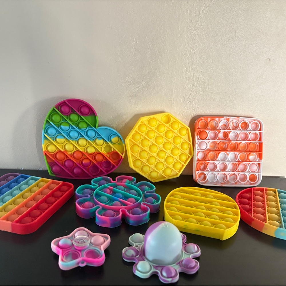 Pop fidget toys. Set of 9. Various shapes/size. One spin fidget. Silicone.